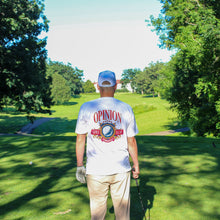 Load image into Gallery viewer, Man walking on a golf course wearing a white t-shirt with text and graphics.