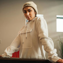 Load image into Gallery viewer, Person wearing a beige hoodie and beanie standing indoors.